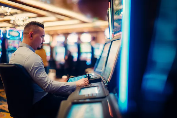 A young woman relaxing with her phone while dynamic casino elements float around her, illustrating the smooth mobile experience offered by the 33L app.
