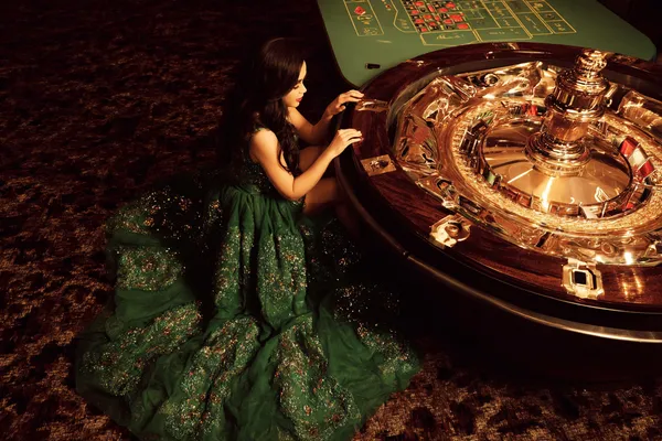 A glamorous woman holding casino chips in a neon-lit environment, representing the premium online casino atmosphere of 33L.